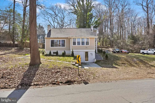 a view of a house with a yard covered in snow