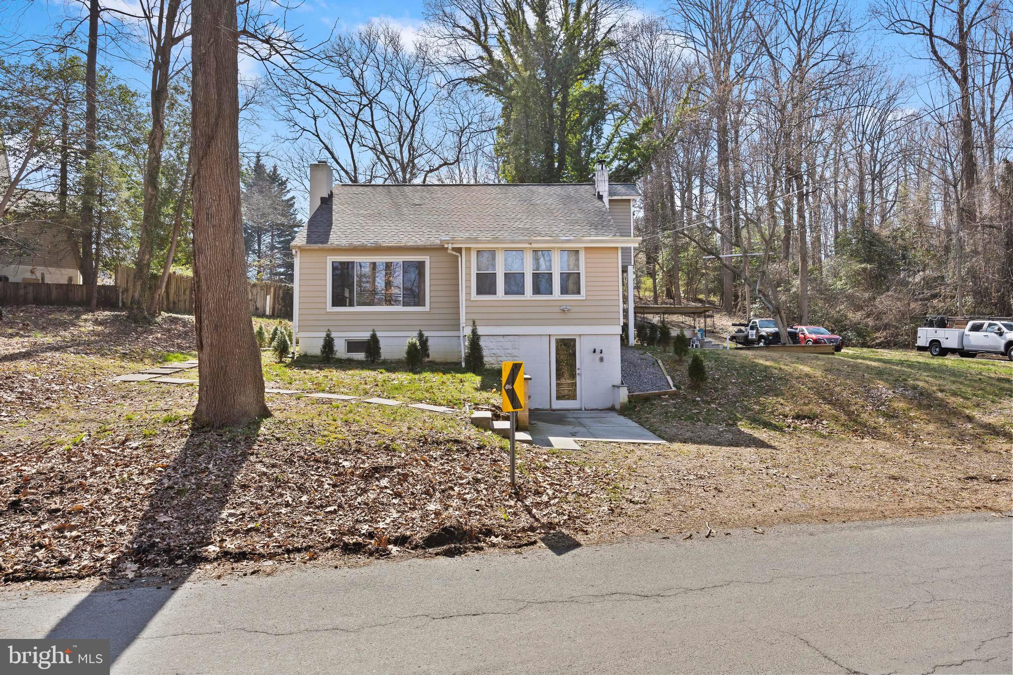a view of a house with a yard covered in snow