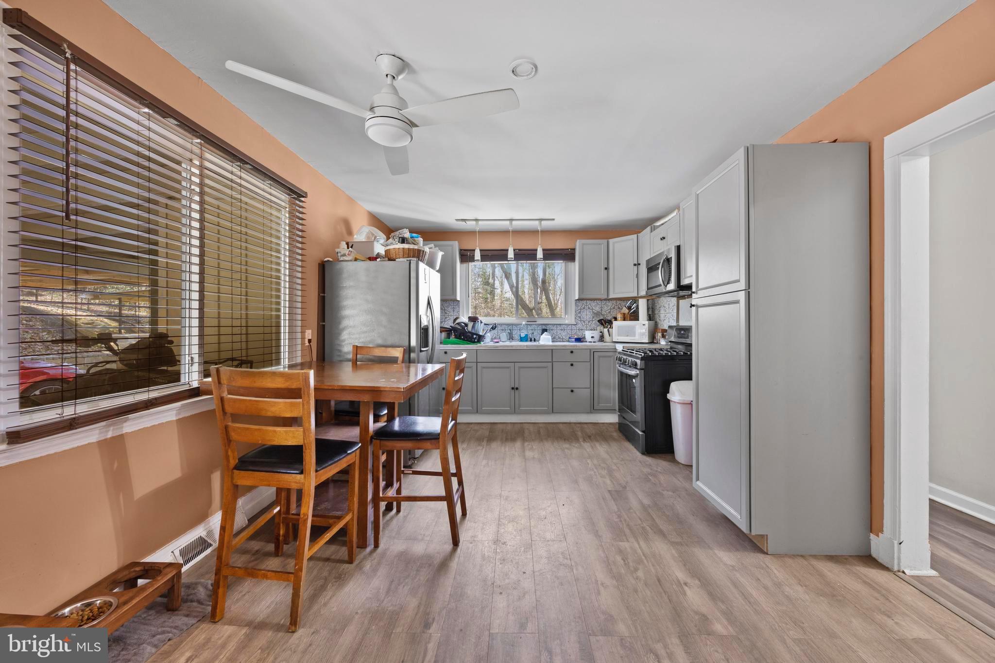 452 Kyle Road Crownsville, MD 21032 - Photo 11 of 46 a kitchen with a table chairs refrigerator and microwave