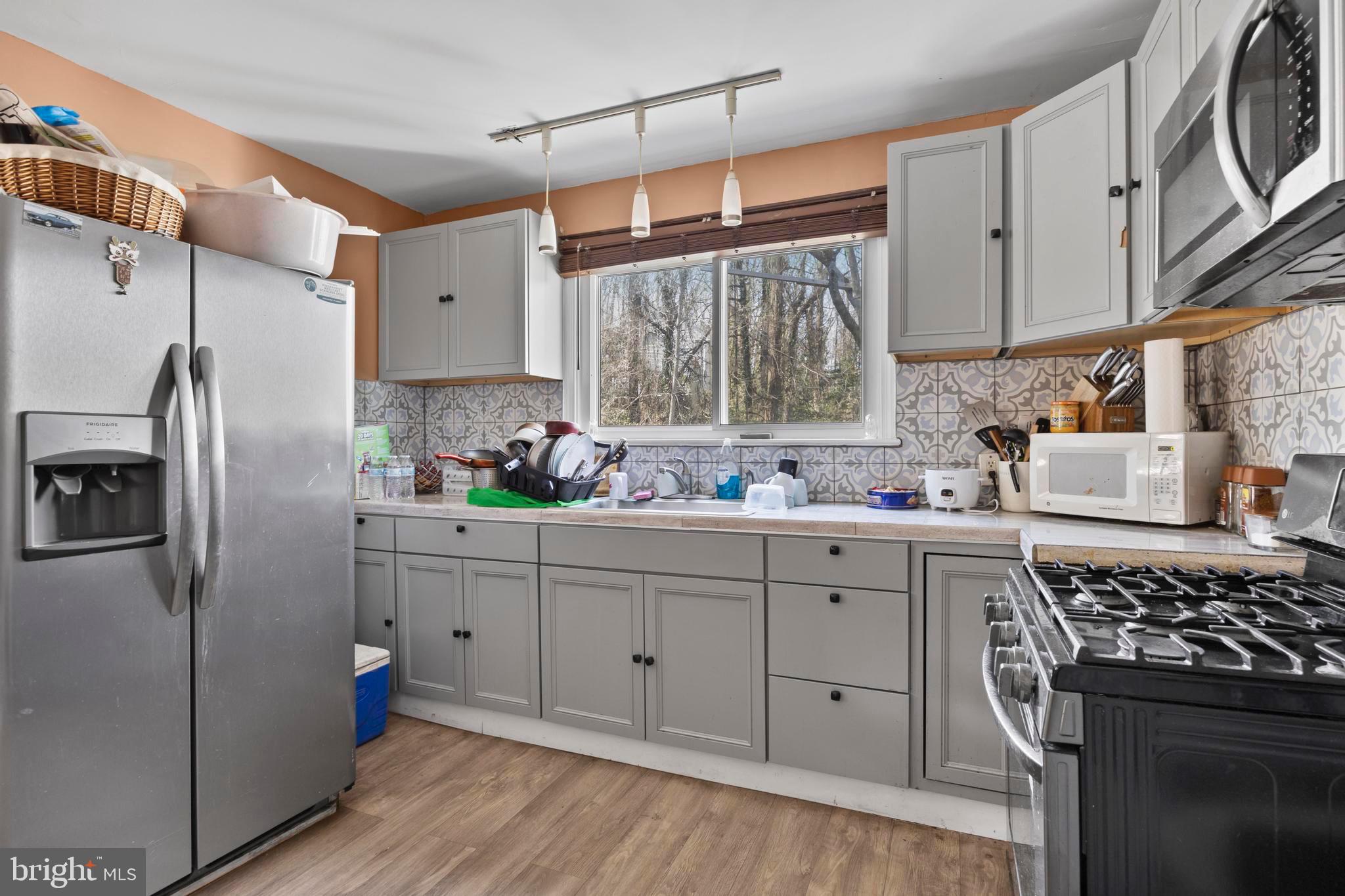 452 Kyle Road Crownsville, MD 21032 - Photo 13 of 46 a kitchen with stainless steel appliances granite countertop a sink stove and refrigerator