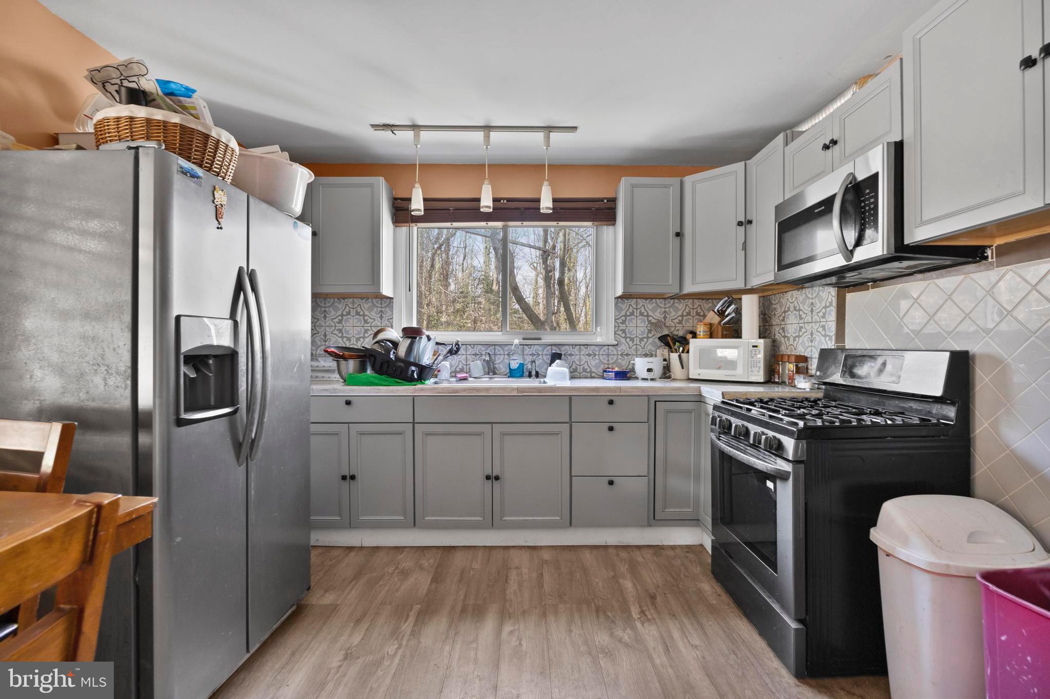 452 Kyle Road Crownsville, MD 21032 - Photo 14 of 46 a kitchen with a stove a sink and a refrigerator