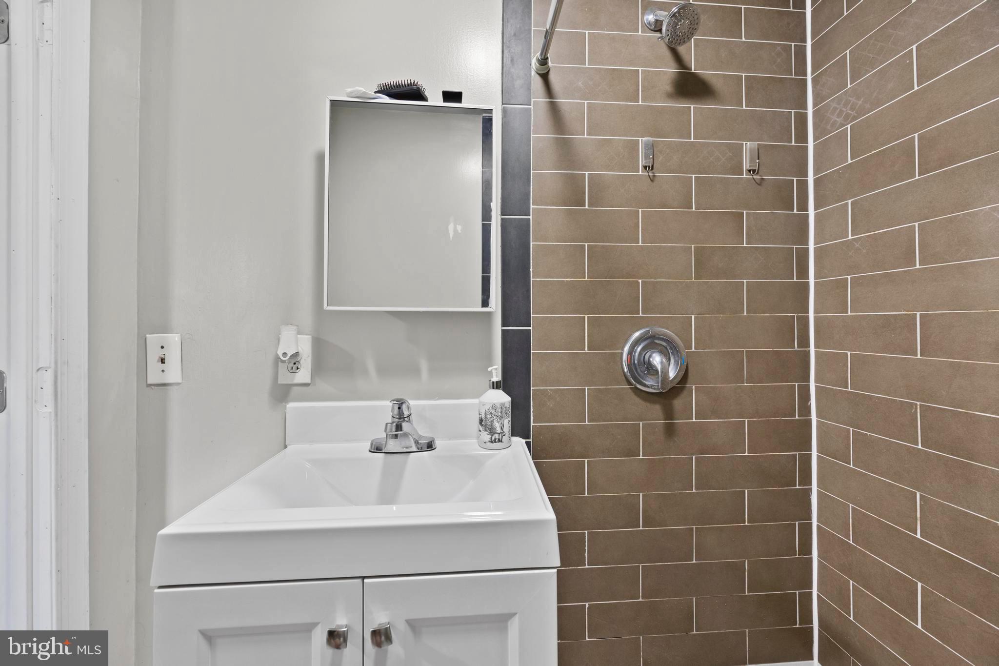 452 Kyle Road Crownsville, MD 21032 - Photo 18 of 46 a bathroom with a sink shower and a mirror