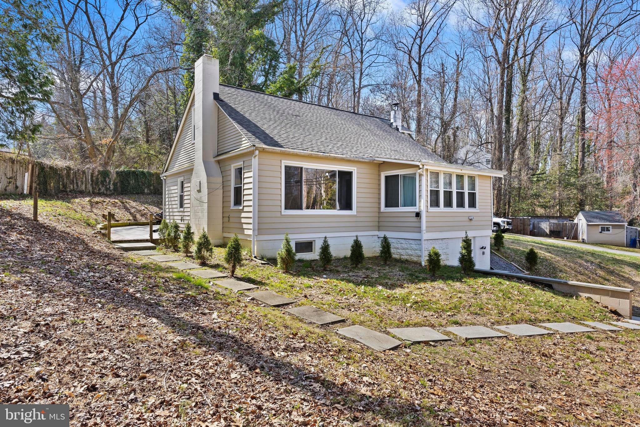 452 Kyle Road Crownsville, MD 21032 - Photo 2 of 46 a view of a yard in front of a house with a large tree