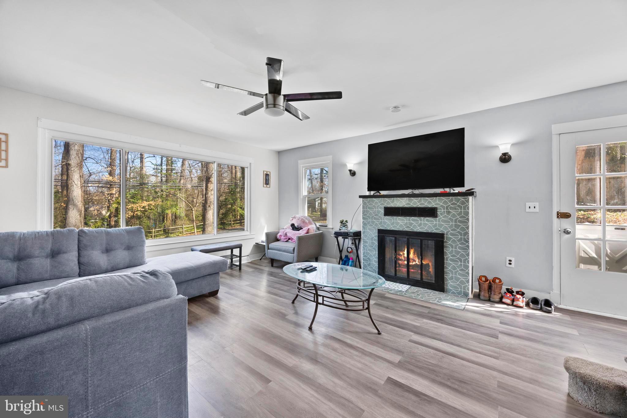 452 Kyle Road Crownsville, MD 21032 - Photo 22 of 46 a living room with furniture a flat screen tv and a fireplace