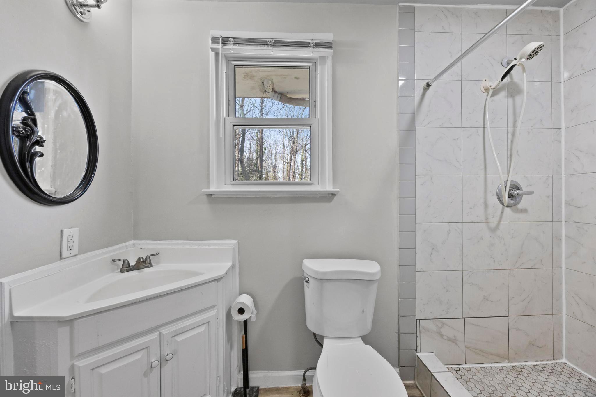 452 Kyle Road Crownsville, MD 21032 - Photo 45 of 46 a bathroom with a toilet sink and mirror