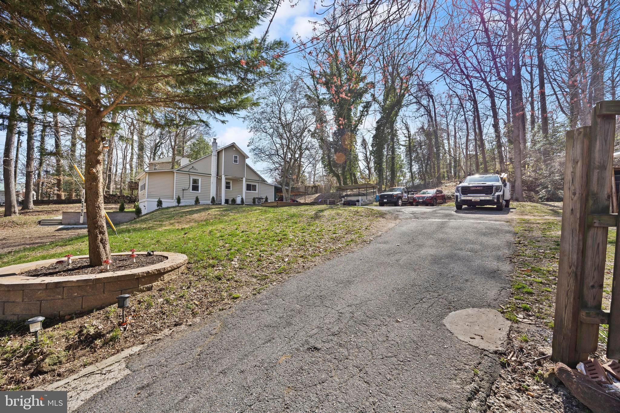 452 Kyle Road Crownsville, MD 21032 - Photo 5 of 46 a view of a house with a yard and large trees