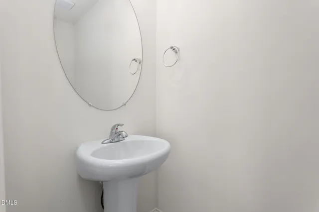a bathroom with a sink and mirror