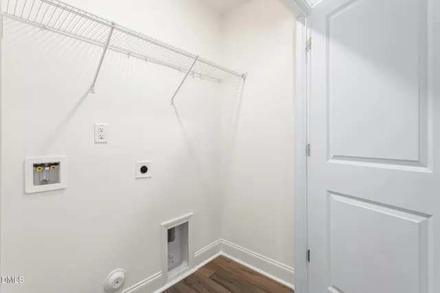 a front view of a house with a garden and plants