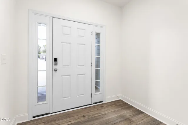 an empty room with wooden floor