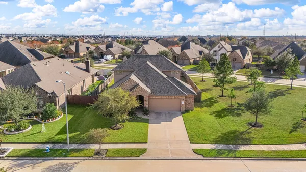 an aerial view of a house with a yard and lake view