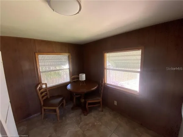 a room with chairs and a window