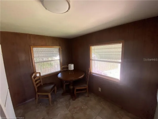 a room with chairs and a window