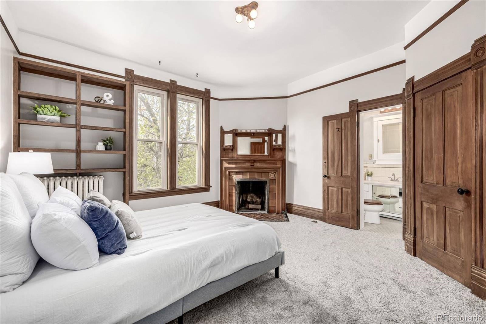 107 Pearl Street, Unit B Denver, CO 80203 - Photo 20 of 39 a bedroom with a bed and a large window
