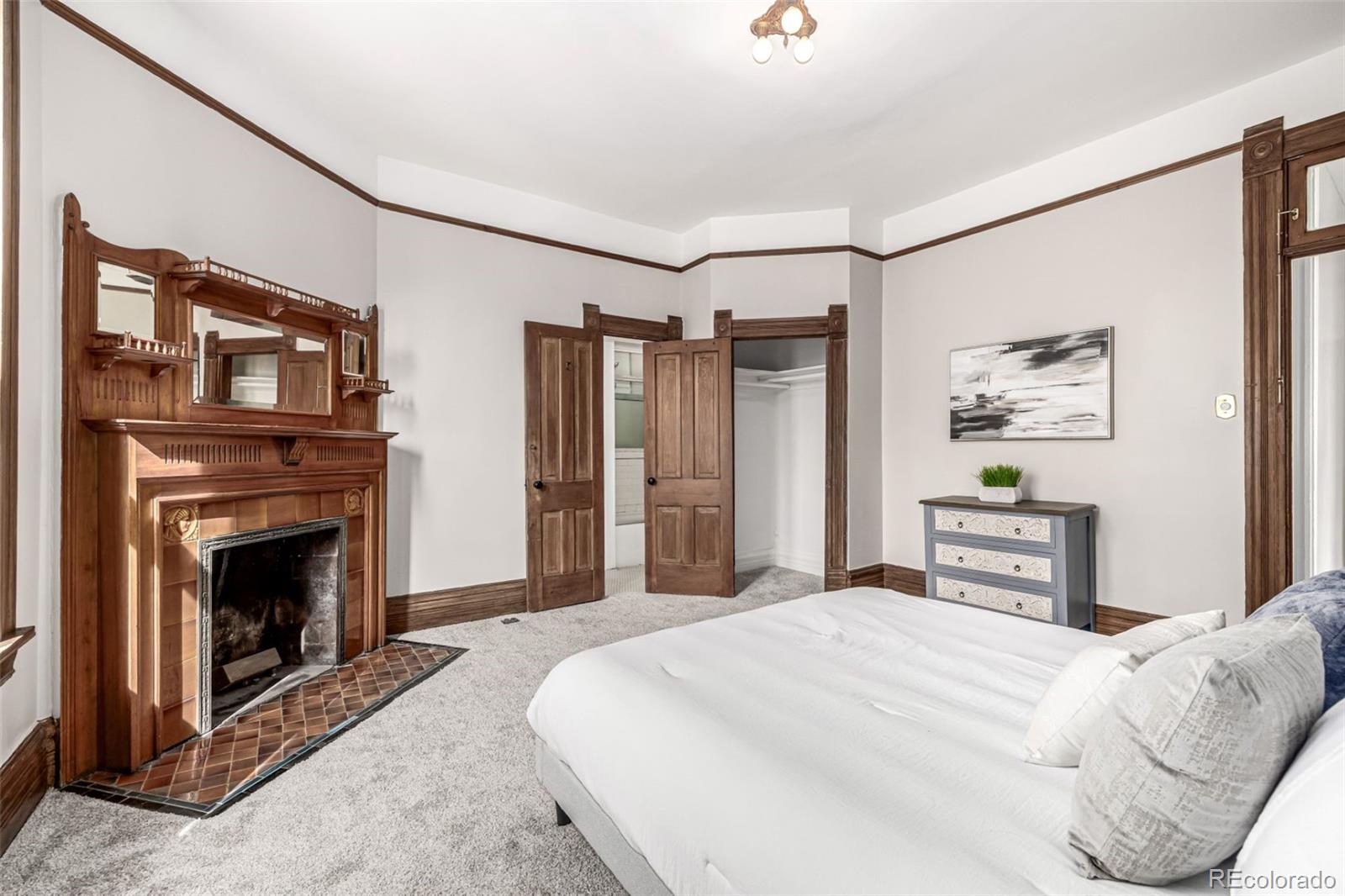 107 Pearl Street, Unit B Denver, CO 80203 - Photo 21 of 39 a bedroom with a bed and a fireplace
