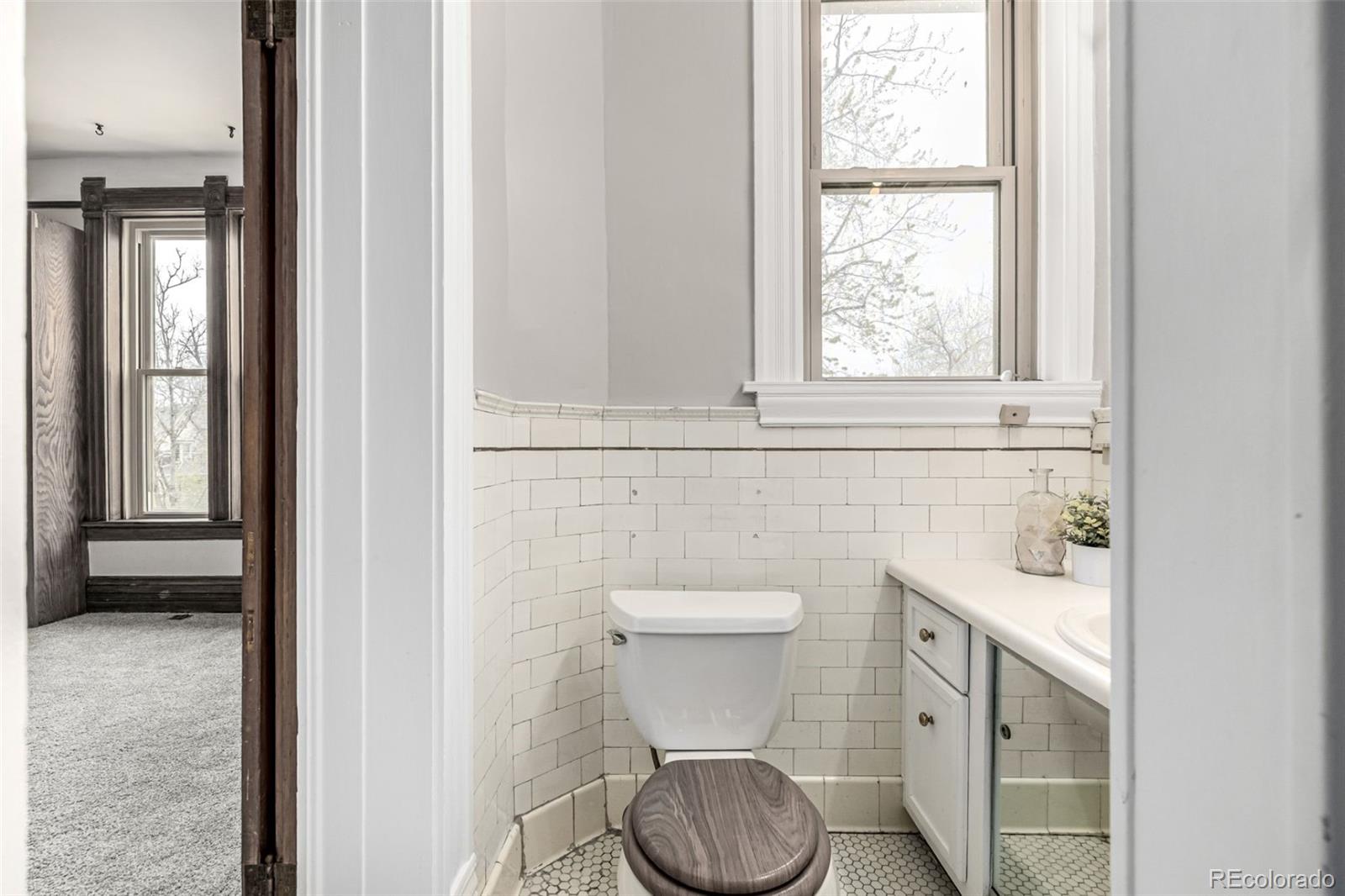 107 Pearl Street, Unit B Denver, CO 80203 - Photo 23 of 39 a bathroom with a toilet sink and window