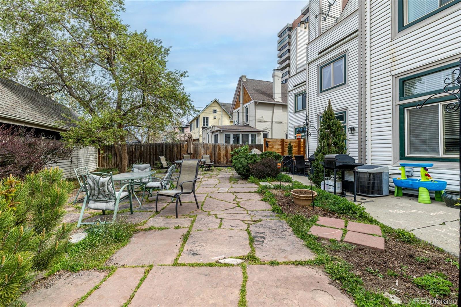 107 Pearl Street, Unit B Denver, CO 80203 - Photo 35 of 39 a view of a patio with table and chairs and potted plants