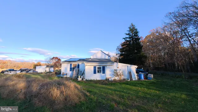 a view of a big house with a big yard and palm trees