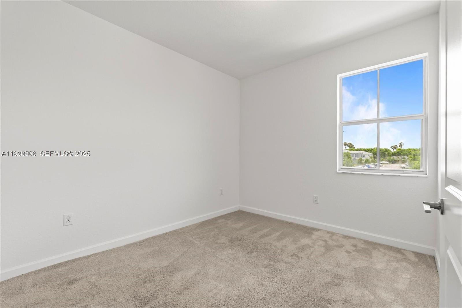 2668 Southeast 19th Street Homestead, FL 33035 - Photo 16 of 37 an empty room with a window