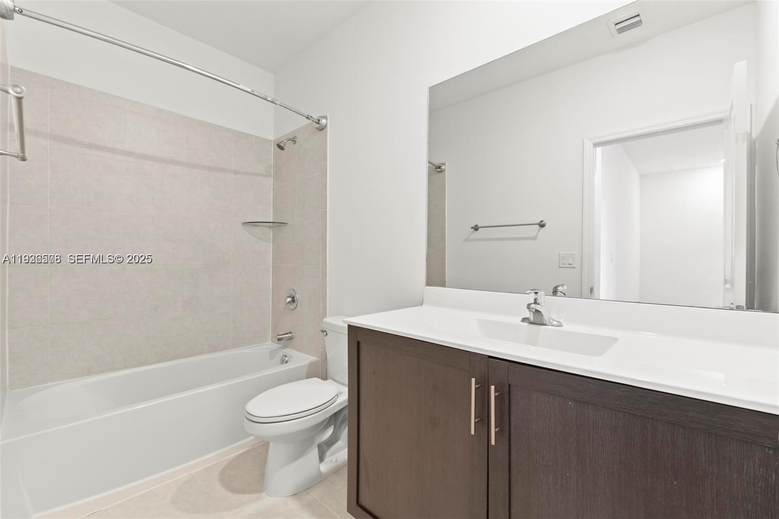 2668 Southeast 19th Street Homestead, FL 33035 - Photo 17 of 37 a bathroom with a granite countertop sink toilet a mirror and shower