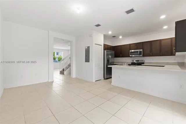 a kitchen with a stove a sink and a refrigerator