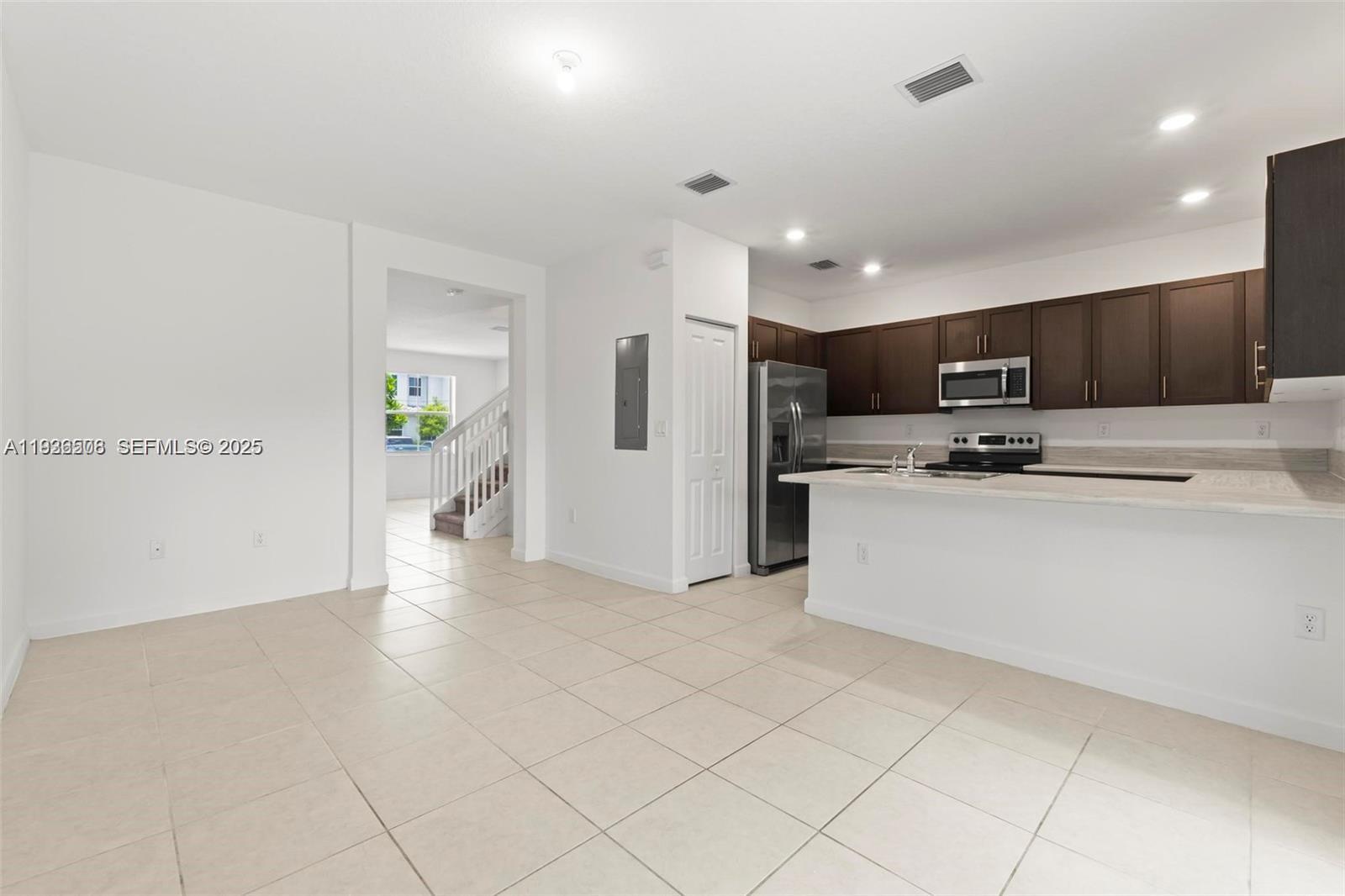 2668 Southeast 19th Street Homestead, FL 33035 - Photo 23 of 37 a kitchen with stainless steel appliances a refrigerator sink and microwave