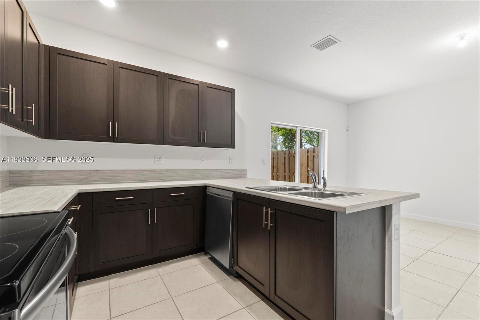 2668 Southeast 19th Street Homestead, FL 33035 - Photo 25 of 37 a kitchen with a sink and cabinets