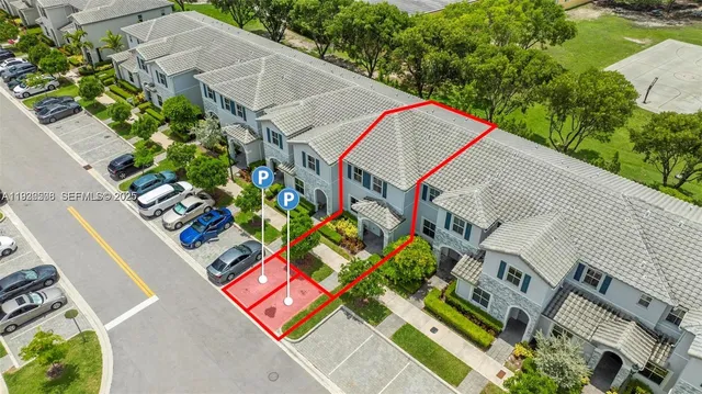 an aerial view of multiple houses with a yard