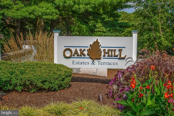 a view of a sign under a tree