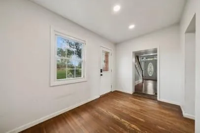 an empty room with a window and closet