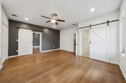 a view of an empty room with a ceiling fan