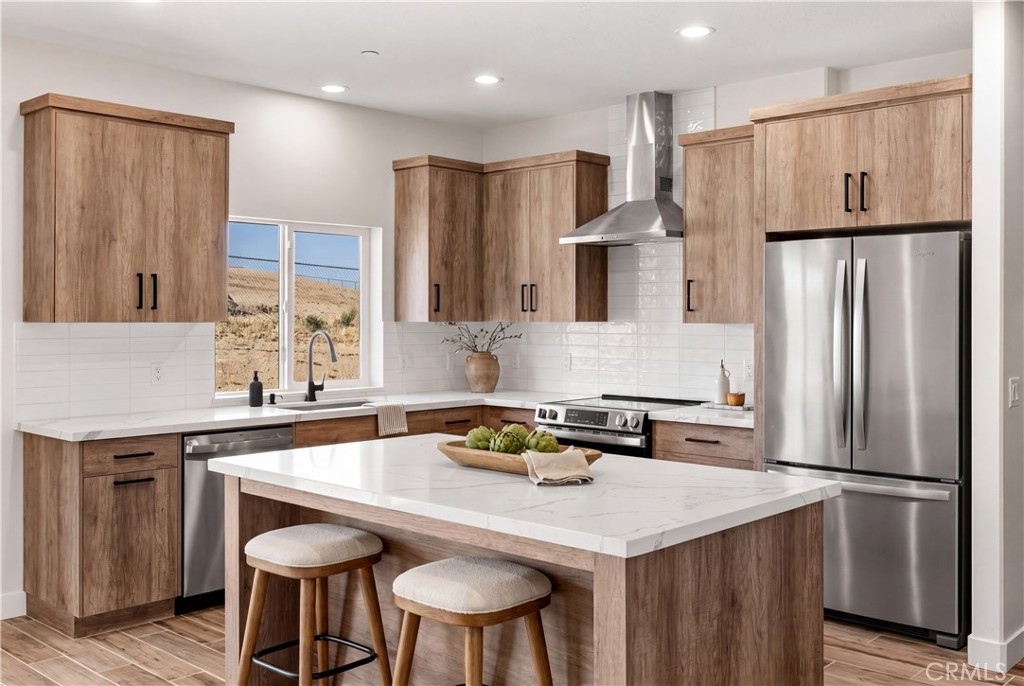 22324 Rancho Street Apple Valley, CA 92308 - Photo 4 of 47 a kitchen with stainless steel appliances a refrigerator a sink a stove a table and chairs