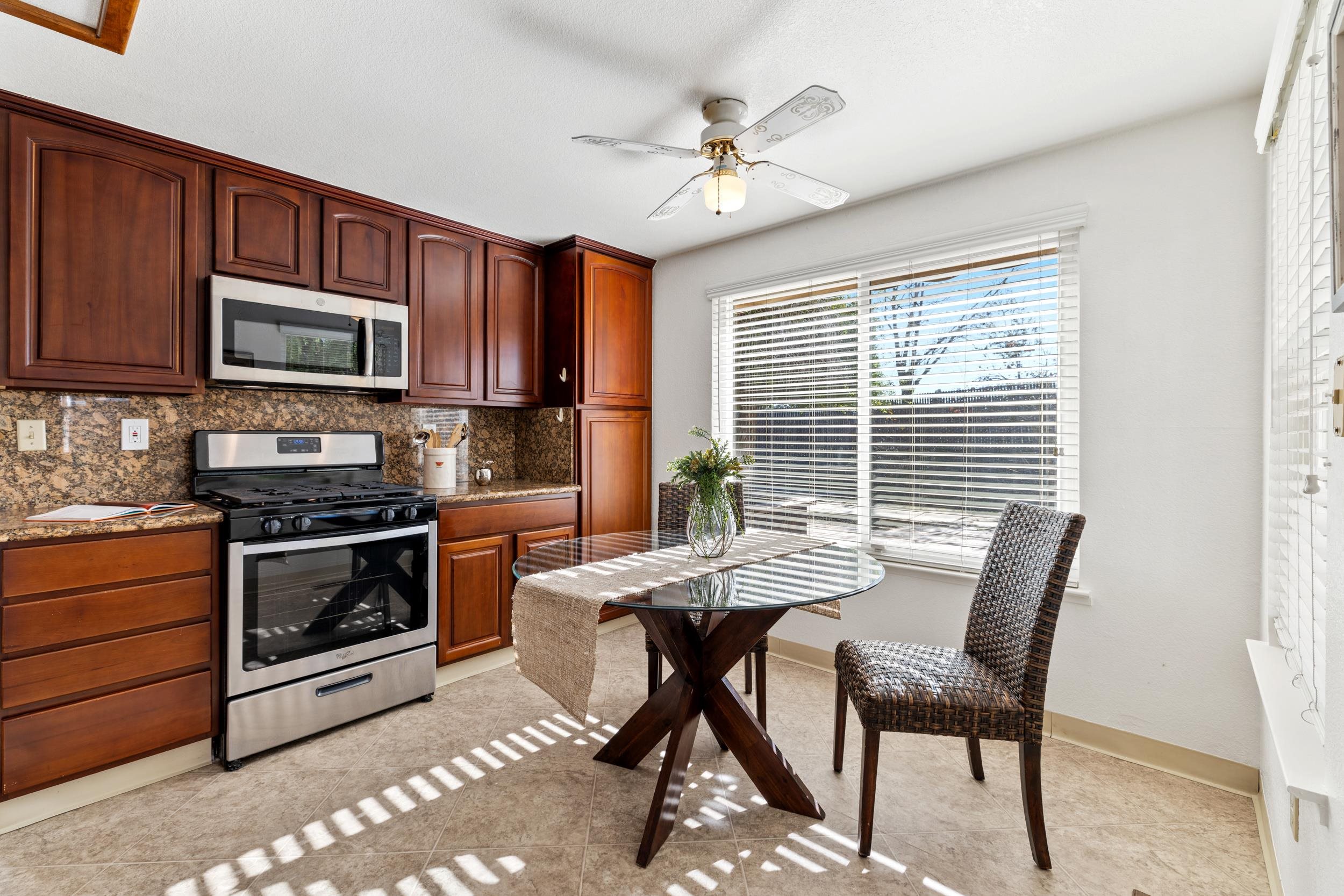 2832 Filbert Street Antioch, CA 94509 - Photo 13 of 40 a kitchen with stainless steel appliances kitchen island granite countertop a stove top oven a sink a dining table and chairs