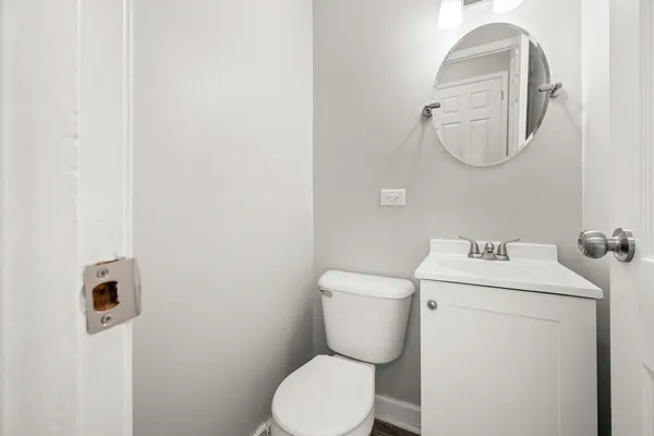 a white toilet sitting next to a bathroom sink