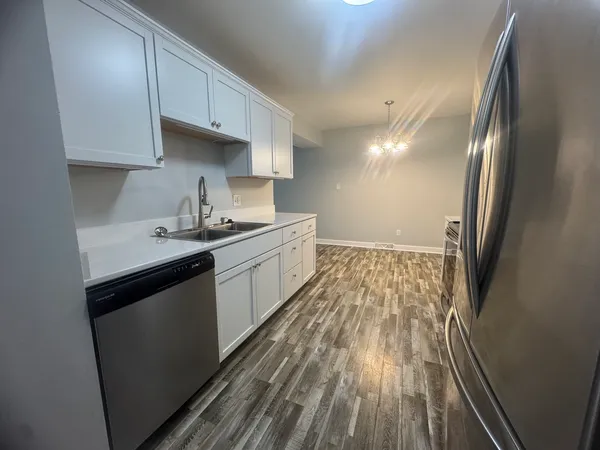 a kitchen with cabinets a sink and appliances