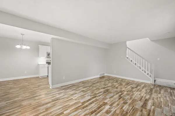 a view of an empty room and wooden floor