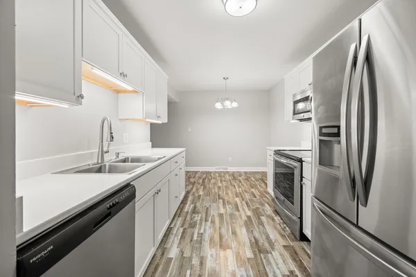 a kitchen with a sink refrigerator and microwave