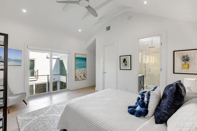 a bedroom with a bed large window and couch