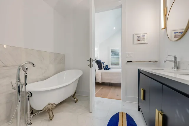 a bathroom with a double vanity sink mirror and shower
