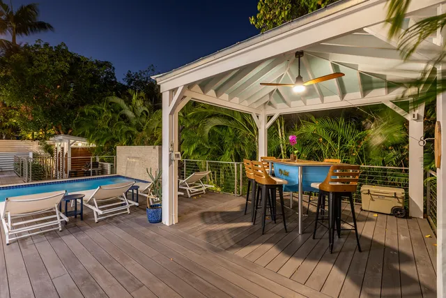 a view of a backyard with table and chairs and a slide