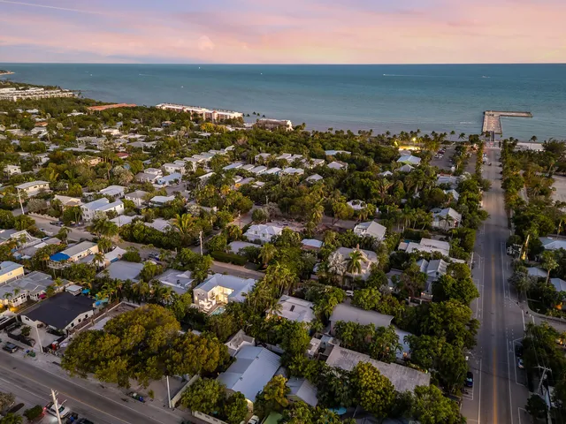 a kitchen with stainless steel appliances kitchen island granite countertop a refrigerator and a sink