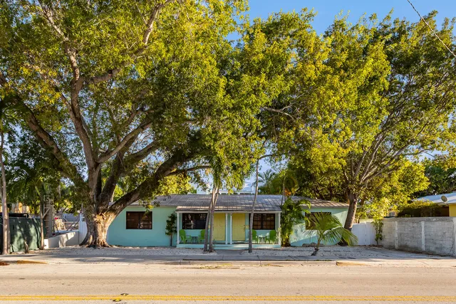 a kitchen with stainless steel appliances kitchen island granite countertop a refrigerator a stove a sink a table and chairs