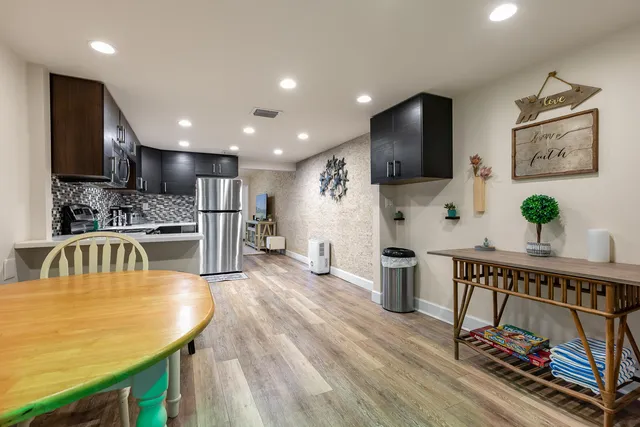 a view of a livingroom with a flat screen tv and stairs