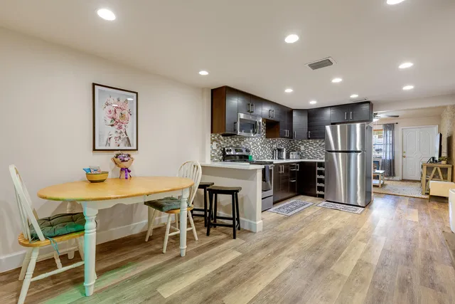 a kitchen with white cabinets and white appliances