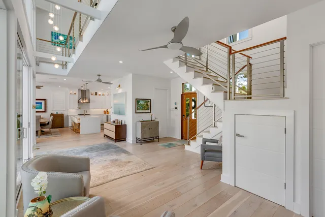 a view of a hallway with a livingroom and stairs