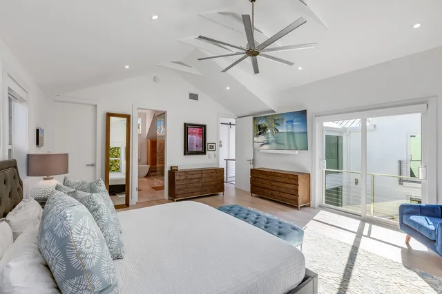 a bedroom with a bed and glass windows