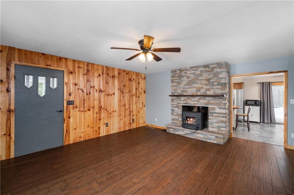 222 Dick Road Prospect, PA 16052 - Photo 14 of 29 a view of a livingroom with a fireplace wooden floor and a chandelier fan