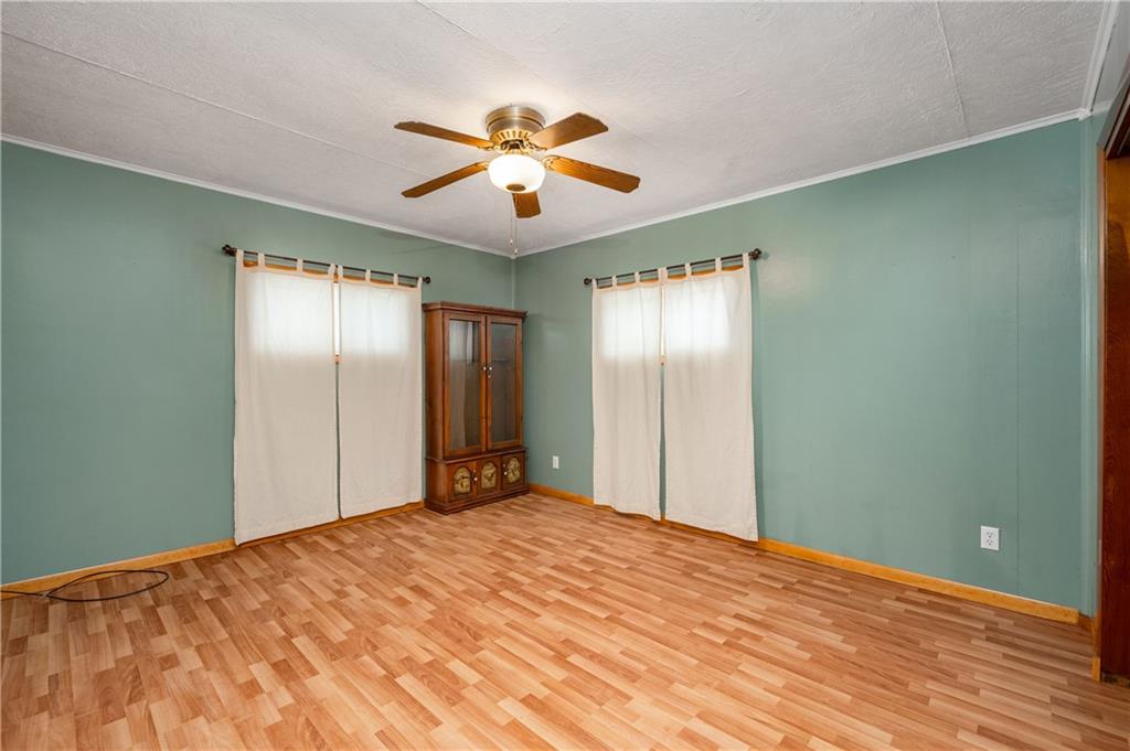 222 Dick Road Prospect, PA 16052 - Photo 21 of 29 a view of a big room with wooden floor and chandelier fan