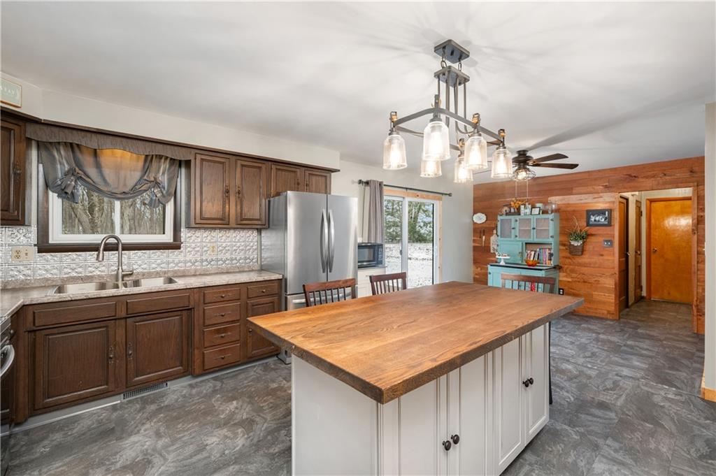 222 Dick Road Prospect, PA 16052 - Photo 6 of 29 a kitchen with center island table and chairs
