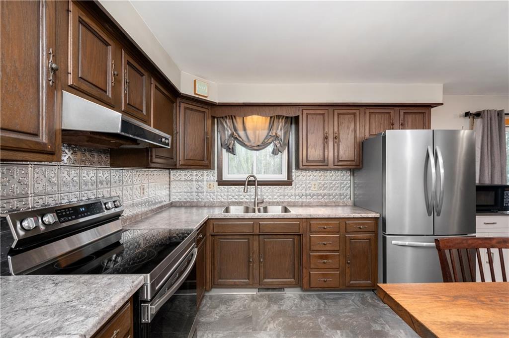 222 Dick Road Prospect, PA 16052 - Photo 7 of 29 a kitchen with stainless steel appliances a stove a sink and a refrigerator