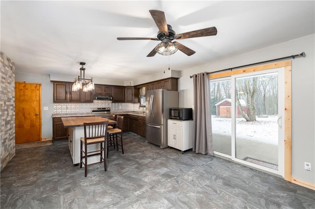 222 Dick Road Prospect, PA 16052 - Photo 8 of 29 a kitchen with stainless steel appliances kitchen island granite countertop a refrigerator a oven a sink with a dining table and chairs